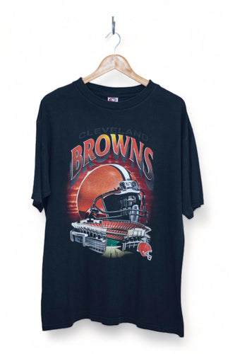 Authentic Cleveland Browns Vintage NFL T-shirt featuring a bold black fade design, showcasing an iconic oversized helmet and a nostalgic depiction of the revered home stadium on the front. Elevate your game day style with this exclusive piece that pays homage to the team's rich history